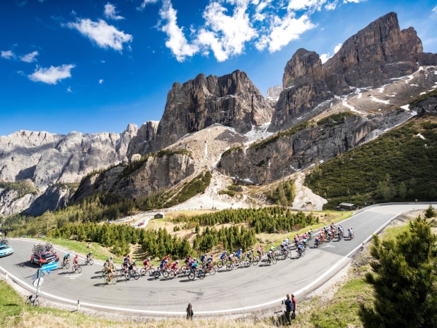 The Dolomites are one of the most photogenic cycling locations in the world. The Giro d&rsquo;Italia riders look as small as ants in comparison to the towering rock formations of the Passo Gardena. Image: Marcus Enno