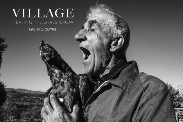 Cover of VILLAGE book. Farmer singing to his favourite chicken in Castiglione, Tuscany - Italy. Image &copy; Michael Coyne.