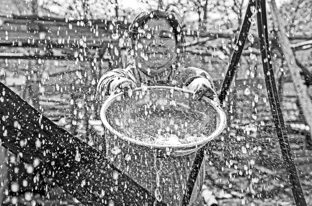 A member of the Mapuche people, collects fresh water from the water tower for her kitchen needs. The Curarrehue commune, Reigolil, Cautin &ndash; Chile. Image &copy; Michael Coyne.