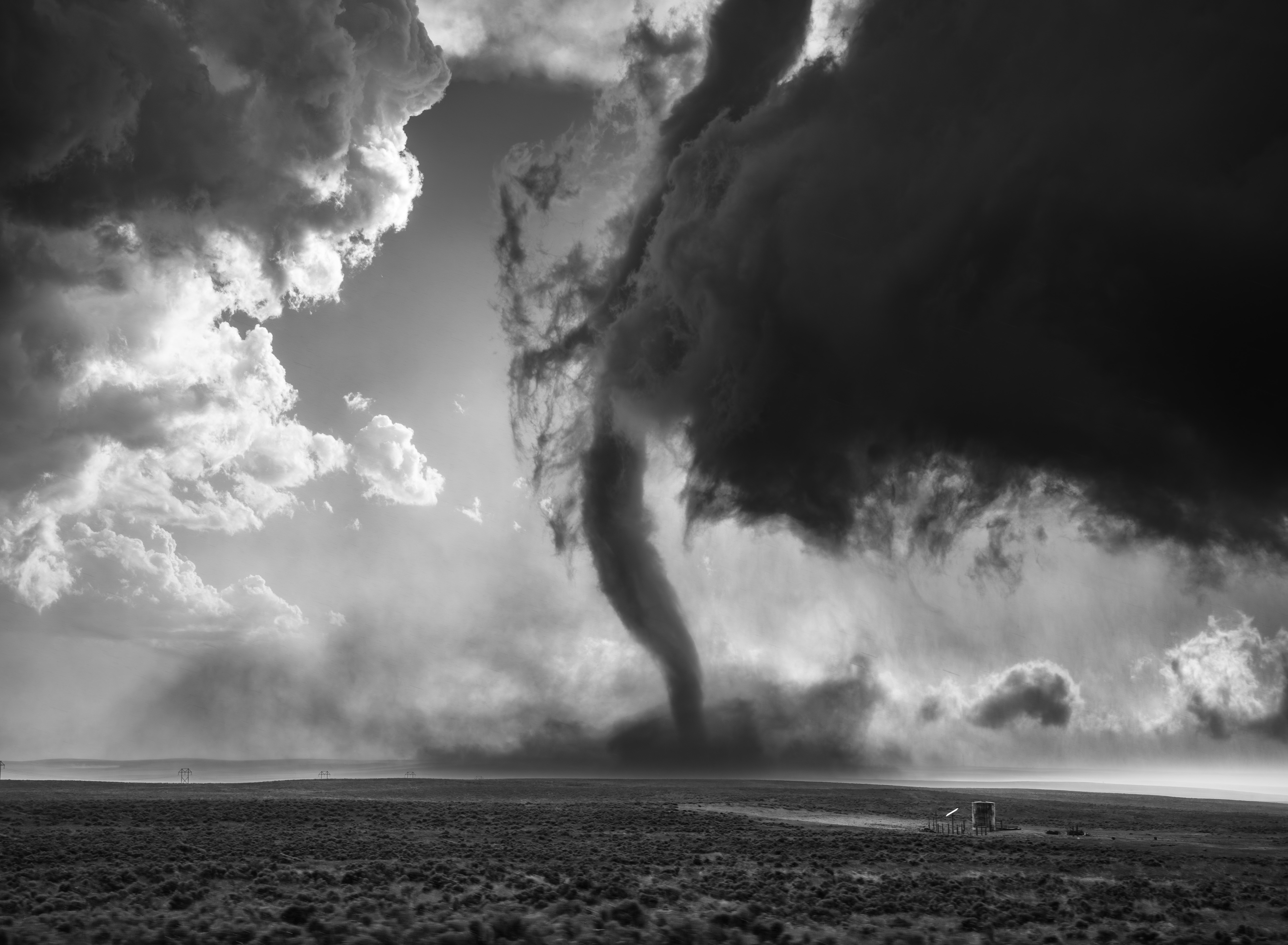 Places category Winner, Will Eades, The heights of Akron. Will Eades’ Places category winning image The Heights of Akron was captured on the U.S. Plains during a storm chase through eastern Colorado. “As the storm structure matured, a violent tornado dropped in front of us, casting dramatic shadows and creating a surreal interplay of light and dust,” he says.“I knew it would be a strong image due to the sheer scale, movement, and the balance between chaos and form — all of which translate powerfully in black and white.”