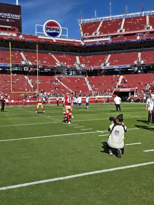 Nikki photographs Niners linebacker Jalen Graham in warm up.