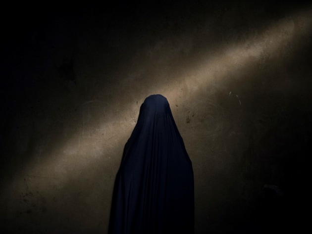 © Adam Ferguson. Nana, 13. “They brought out a belt and tied it to my waist and showed me a button to press.” From the series, The Bombs They Carried.