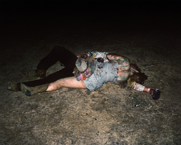 © Adam Ferguson. A young man and woman kiss on the ground at a Bachelor and Spinster Ball at The Rock in New South Wales, 2019.