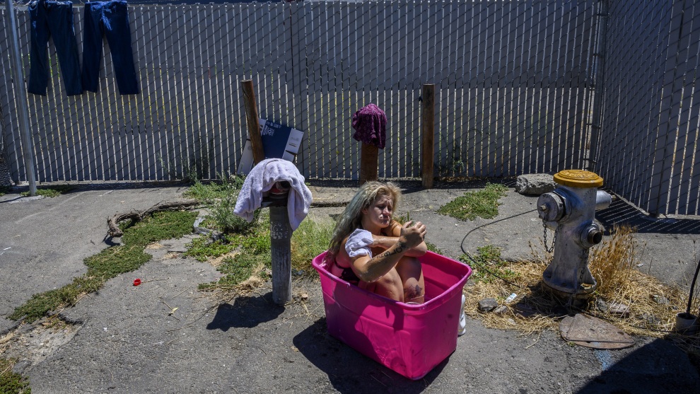 &copy; Ren&eacute;e C. Byer/The Sacramento Bee. 1.	Laurane Ivey, 37, sinks deep into a pink plastic tub filled with water from a fire hydrant as she begins to scrub the dirt from her worn feet. Above her is a barbed wire fence surrounding the shelter she used to live in before it closed. With no place to go she lives in her car joining other homeless in parked cars across the street including her mom Gwen Mayes, 59, who sleeps with two tiny dogs for protection. She says she wished there was a designated parking spot for the homeless with showers and portable toilets. She says she has to go to the bathroom in a bag inside her car.