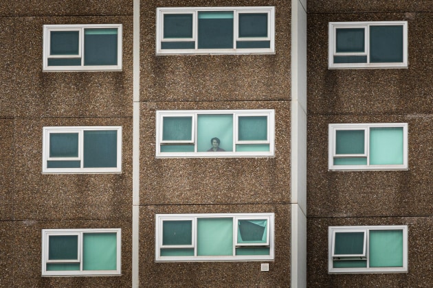 Melbourne Residents On Stay At Home Orders As Victoria Imposes. Further Postcode Lockdowns As COVID-19 Cases Rise
A lone woman is seen looking out the window of her apartment at the North Melbourne Public housing flats on July 05, 2020 in Melbourne, Australia. Nine public housing estates have been placed into mandatory lockdown and two additional suburbs are under stay-at-home orders as authorities work to stop further COVID-19 outbreaks in Melbourne. The public housing towers will be in total lockdown for at least five days following a high number of positive coronavirus cases recorded in residents on those estates. The towers will be closed and contained, and the only people allowed in and out will be those providing essential services. Police will be placed on each floor of the towers and other police will control access points to the estates.