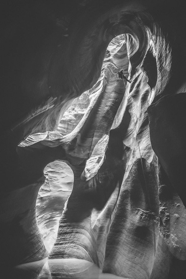 Zion canyon. This image was taken deep within a very steep and remote canyon in Zion National Park in the USA with my good friend and amazing US photographer Taylor Glenn. I had just rappelled down here before him and swam through freezing water to a very slippery and muddy edge to turn and capture him coming down behind me. I fell in the water straight after this shot and just managed to save the camera. I love the adventure and adrenaline of this moment, but also the bones of the earth like feel of the rock structures themselves. Image: Paul Hoelen