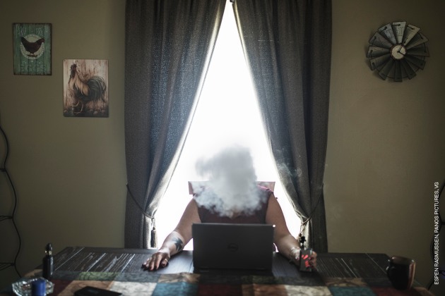 White Rage - USA. &copy; Espen Rasmussen, Panos Pictures, VG. 
CONTEMPORARY ISSUES - THIRD PRIZE, STORIES.
Degrees of rage in three US states: a journey made in the weeks after the Unite the Right rally in Charlottesville, Virginia. The rally was the first gathering of far-right groups from all over the country in decades, held in part to demonstrate opposition to the removal of the statue of Confederate general Robert E. Lee.
The photographer travelled through Virginia, West Virginia and Maryland meeting a range of people, from extreme right activists to patriots and those angry at the way the US is governed, in an attempt to understand why white anger has risen to the surface.
24 September 2017. Lorri Cottrill (45), leader of the US neo-Nazi National Socialist Movement, smokes an e-cigarette in her home in Charleston, West Virginia.