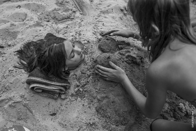 Ich Bin Waldviertel. &copy; Carla Kogelman.
LONG-TERM PROJECTS - FIRST PRIZE
Hannah and Alena are two sisters who live in Merkenbrechts, a bioenergy village of around 170 inhabitants in Waldviertel, an isolated rural area of Austria, near the Czech border.
The girls have two older brothers, but spend much of their time together in a carefree life, swimming, playing outdoors and engrossed in games around the house. A bioenergy village is one which produces most of its own energy needs from local biomass and other renewable sources.
The photographer has been photographing Hannah and Alena since 2012. She visits them for a few weeks, usually at summertime, every year, watching them growing up and spending time together.
16 July 2014. Alena and Steffi play in the sand.